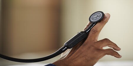 A close up of a Littman CORE Digital stethoscope resting on a persons fingers
