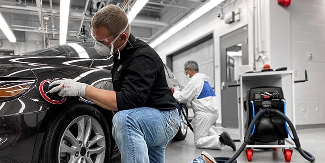 Image showing a man using pair premium Abrasives with premium tools on a car to achieve excellent results
